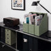 Elegant sage-green A4 magazine files on an office shelf, neatly organizing documents, beside a retro radio and stylish lamp.